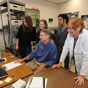 students and faculty at a computer